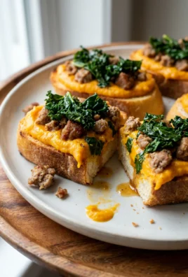 A close-up shot of a single butternut squash crostini showing all the layers.