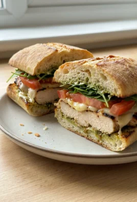 A close-up of a finished Italian chicken sandwich showing all the delicious layers.