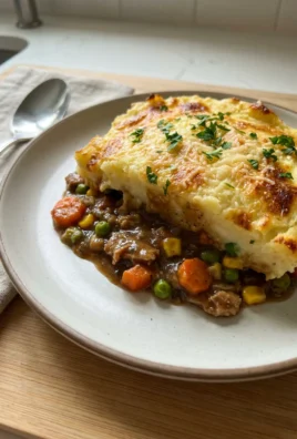 A close-up of the golden-brown mashed potato topping on the finished shepherd's pie.